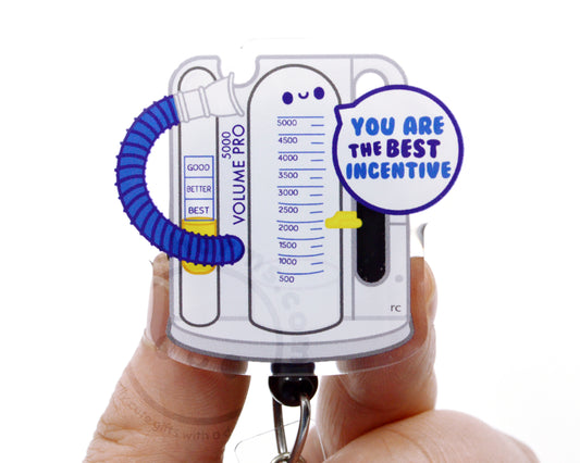 A person's hands holding a keychain with a cartoon image of a ventilator and a speech bubble saying "You are the best incentive".