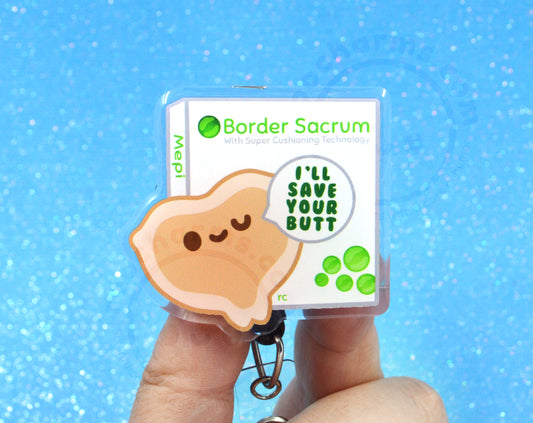 A person's hand holding a keychain with a cartoon image of a dumpling and text that says "I'll save your butt" in a speech bubble.