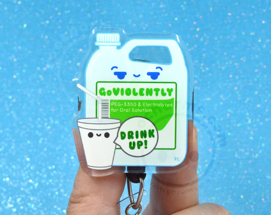A person's hand holding a keychain with a cartoon image of a cup and a bottle, along with text that says "GOVIOULENTLY PEG-3550 & Electrolytes for Oral Solution DRINK UP!".